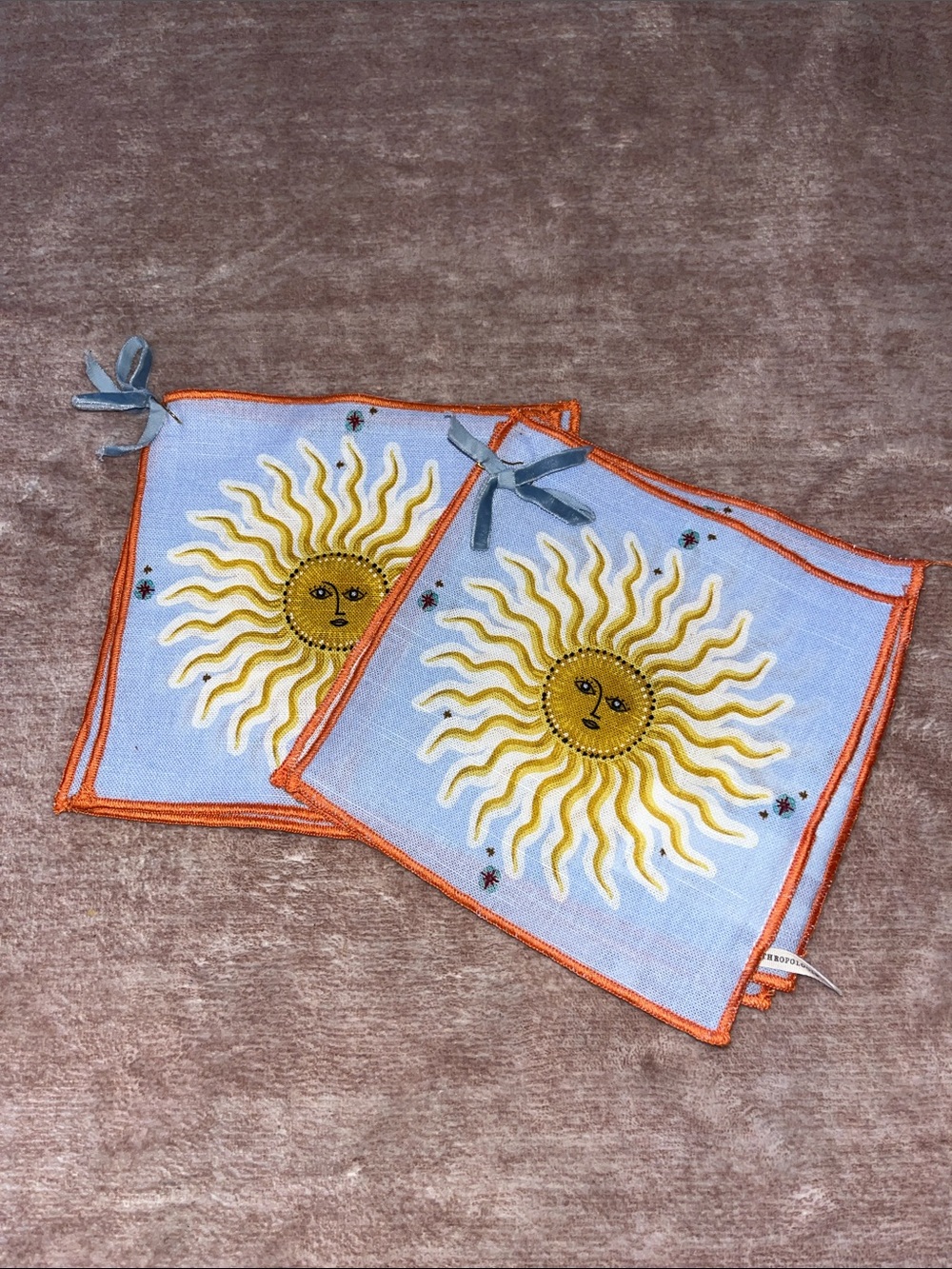 Sun Embroidered cocktail napkins with Orange Trim